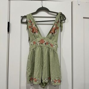 Green romper with floral embroidery